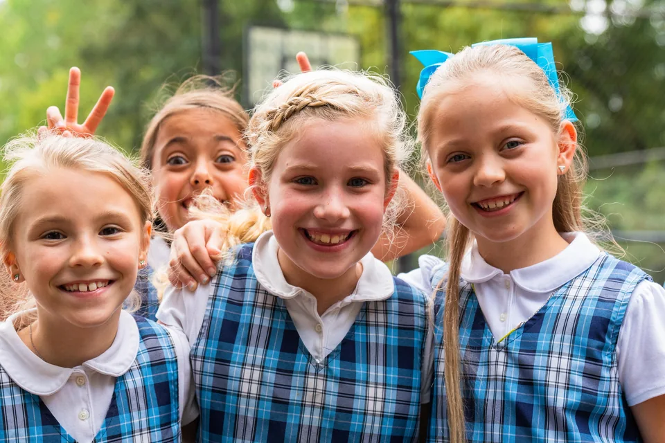 Four students smiling together outdoors at ACA